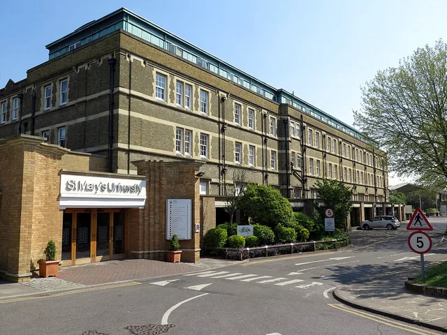 View of the university campus in Twickenham, with historic buildings behind open ground.
