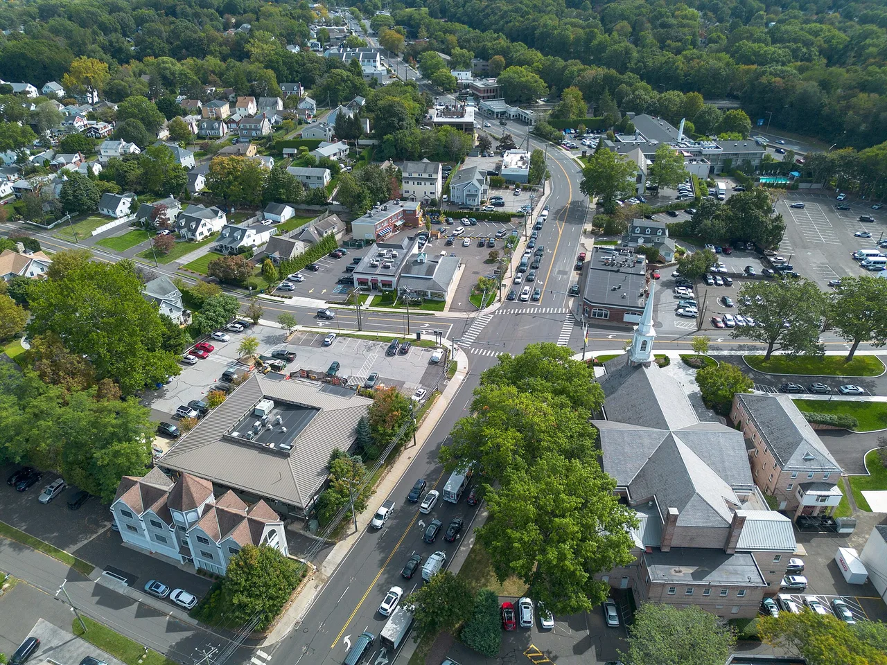 An aerial view of a leafy waterside neighbourhood of houses and trees on the Connecticut coast.