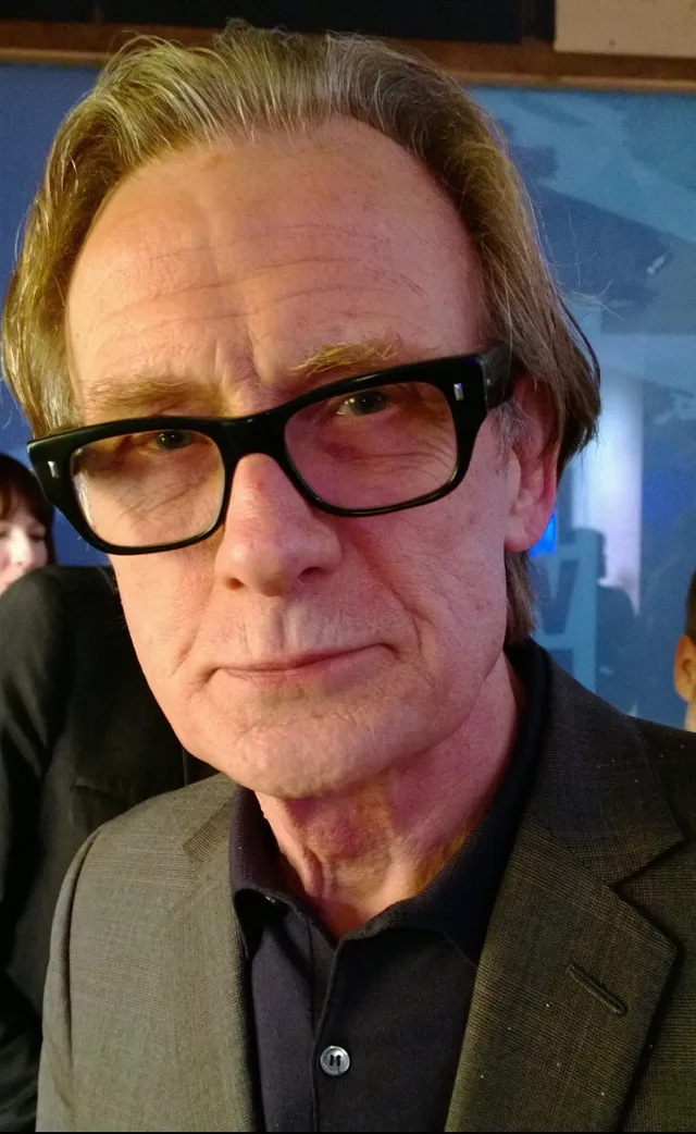 Bill Nighy at a launch event in 2013, in a dark suit.