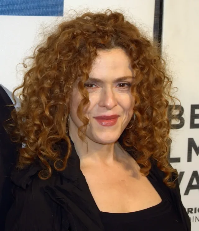 Bernadette Peters with curly auburn hair, smiling slightly, photographed at a film festival event.