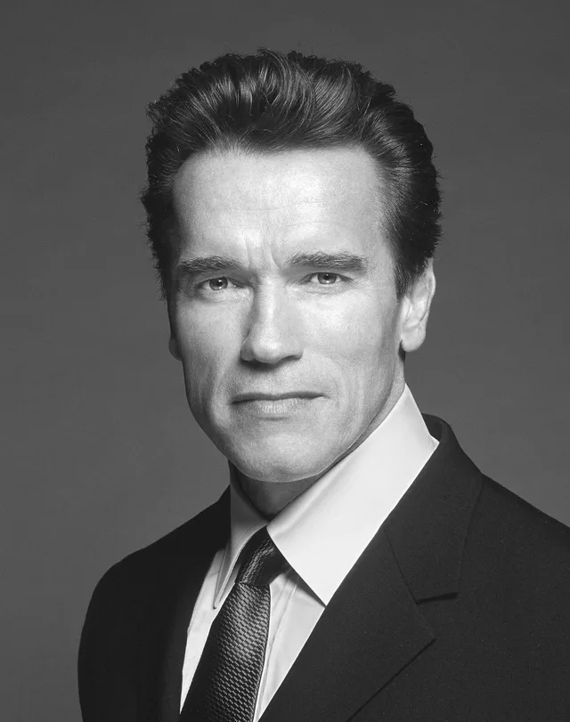 Head and shoulders portrait photograph of Arnold Schwarzenegger in a suit.