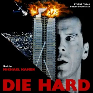 Album cover: a skyscraper with flames at its top and a helicopter beside it, next to a startled man's face, with the title in large red letters below.
