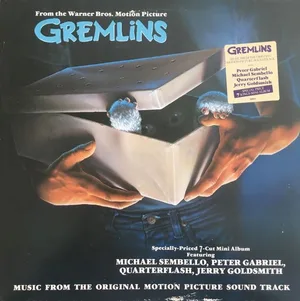 Vinyl sleeve showing two hands lifting the lid of a cardboard box, with small furry creatures peering out against a dark blue background.