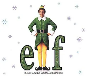 Album cover with a figure in a green elf outfit and pointed hat, hands on hips, above large green lettering on a white background with pale snowflakes.
