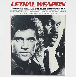 Album cover showing two men in close-up, one fair and one dark-skinned holding a gun, with red title lettering across the top and performer credits in small print below.