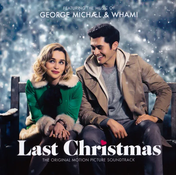 Album cover showing a smiling couple on a snowy bench, a woman in a green fur-trimmed coat and a man in a tan jacket, with falling snow behind them.