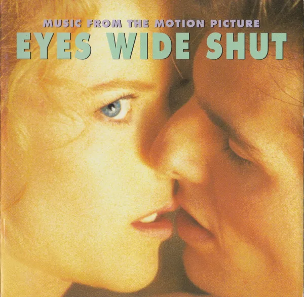 Album cover in warm amber tones: a close crop of a woman and a man about to kiss, with the film title in large pale green capitals across the top.