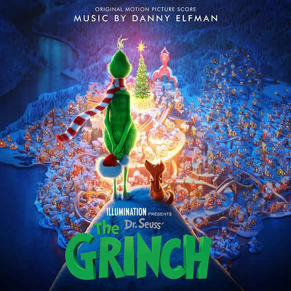 Album cover of a green furry animated figure in a red and white striped scarf seen from behind on a hilltop, looking down over a snowy, brightly lit toy-like town at night.