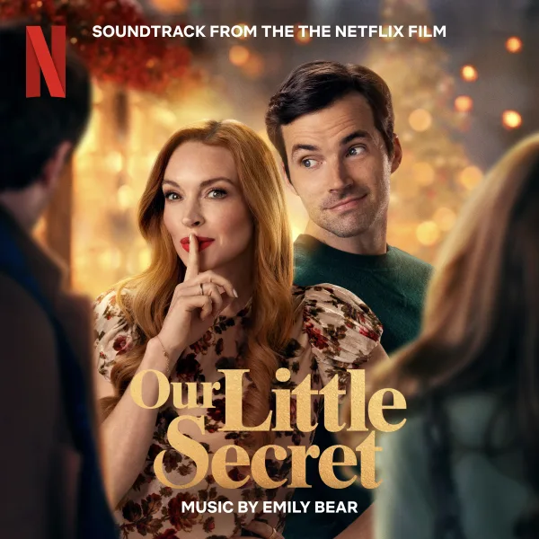 Album cover with a woman with long red hair holding a finger to her lips and a smiling man peering over her shoulder against warm festive lights, with gold lettering below.