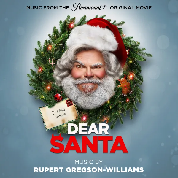 Album cover: a bearded man in a red hat framed by a Christmas wreath, an envelope tucked into it, on a pale blue background with the film title below.