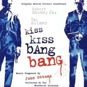 Square album cover in blue and white with two men holding guns on either side, a woman at lower right, and hand-lettered title text with a red splatter.