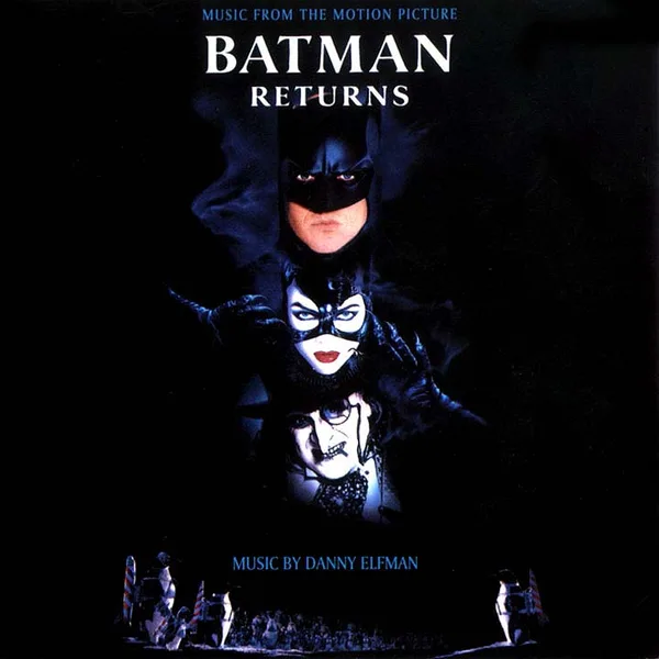 Dark album sleeve with three masked and made-up faces stacked above a small orchestra, white title lettering at the top and the composer credit at the foot.