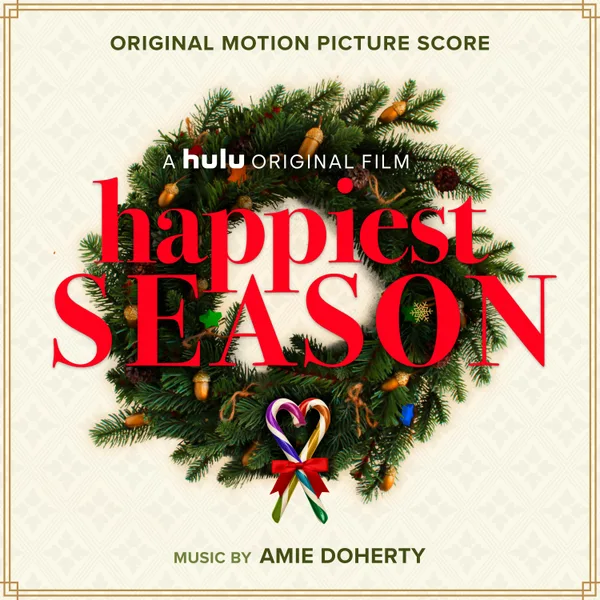Cream album cover with a gold border, showing an evergreen wreath studded with acorns and a candy cane heart tied with a red bow, under red serif title lettering.