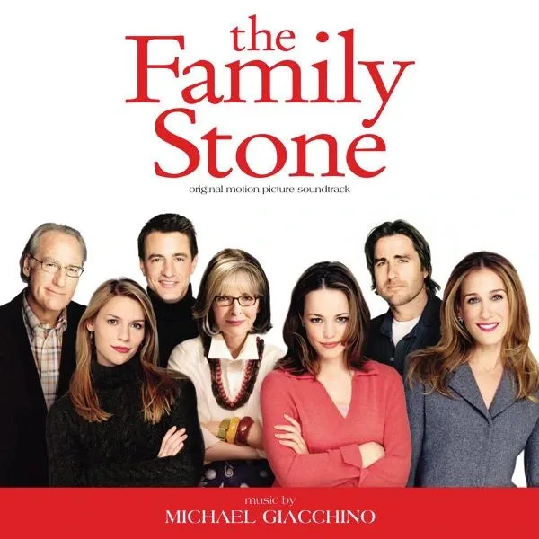 Score album cover with red title lettering above a row of seven adults standing close together, in knitwear and jackets, on a white background with a red band below.